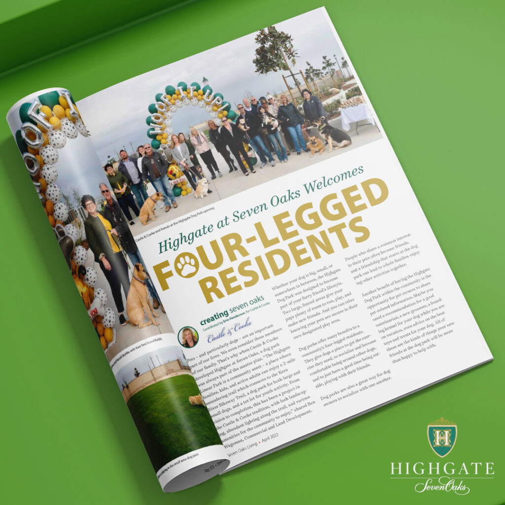 An open magazine spread on a green background featuring an article titled "highgate at seven oaks welcomes four-legged residents," with a photo of a group of people and dogs under a decorative arch.